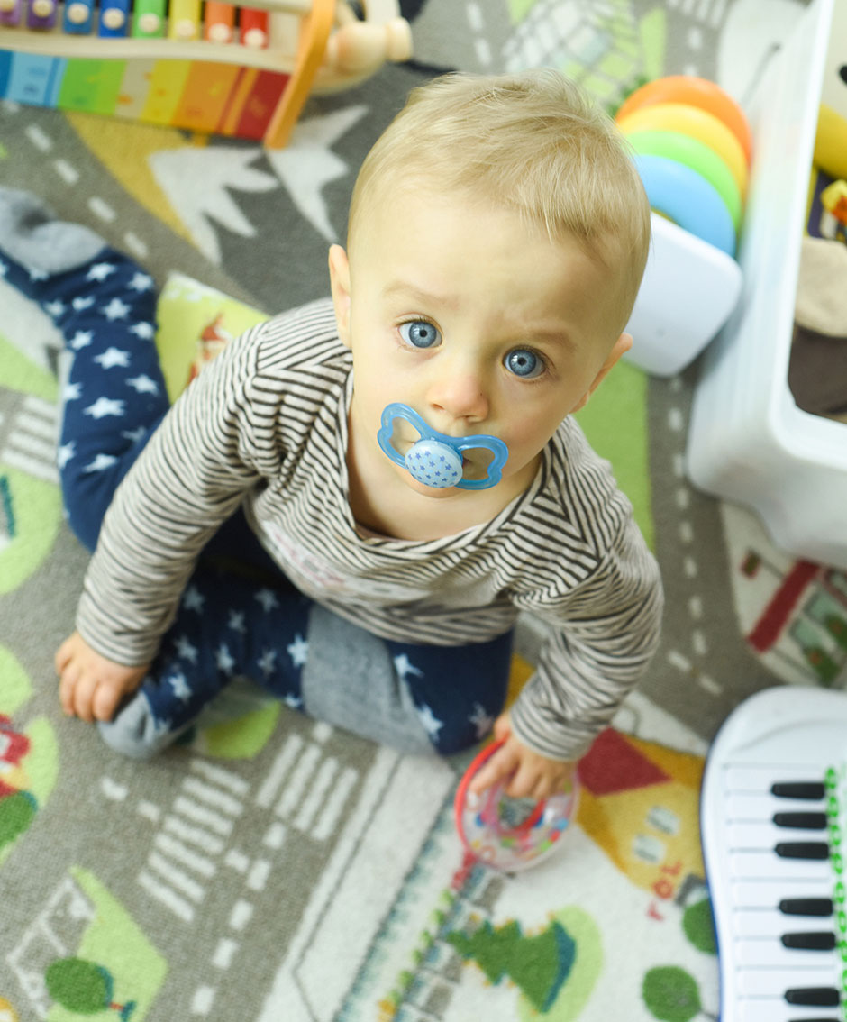 Kinderfoto zuhause mit Blick in Kamera, Familienfotograf Berlin